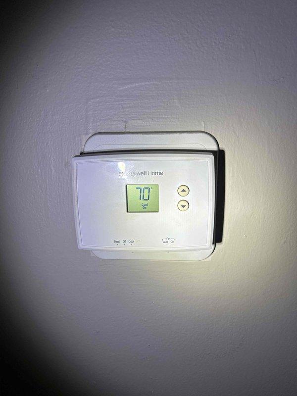 Responded to no cooling complaint on unit #4 with history of multiple compressor replacements. Performed diagnostic evaluation of system operation, checked thermostat functionality showing 70-degree cooling setpoint, and inspected air return filter grille at interior threshold location. Contacted property manager with diagnostic findings prior to proceeding with any repairs per special instructions, and documented system conditions with photos for review.