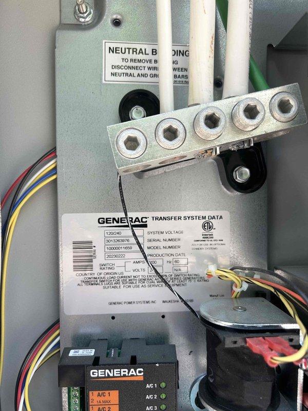 Performed routine maintenance on an 18KW Generac residential standby generator connected to propane fuel supply. Conducted comprehensive system inspection including visual assessment of generator housing, transfer switch components, and electrical connections. Documented unit condition with photographs showing proper installation on concrete pad, adequate clearances from structure, and secure propane tank proximity. Inspected transfer system data label and verified neutral bonding configuration within automatic transfer switch panel. Confirmed all wire terminations at neutral bus bar were secure and properly organized. Checked control module LED indicators and system status lights for proper operation.