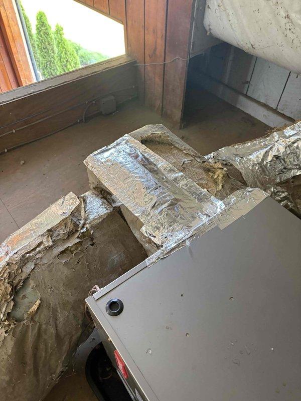 Completed full residential heat pump system installation including Bryant 2-ton outdoor heat pump unit (model GH5SAN52400A), Bryant 2-ton air handler (model FJ5ANXB24L00), and Bryant 10 kW electric heat kit (model TU-EC-10BKB) with digital thermostat. Installed outdoor unit pad with snow legs, electrical whip kit, and disconnect box for code-compliant power supply. Applied refrigerant line insulation and installed refrigerant line filter for system protection. Added foil duct wrap to insulate exposed sections of supply ductwork where deterioration was evident. Configured air handler with condensate trap, SS2 coil drain safety water sensor, and ceiling saver overflow drain pan with secondary water sensor for leak protection. Fabricated transition connections to integrate with existing ductwork system and installed standard-sized air filter rack. Removed and disposed of existing HVAC equipment per regulations. Pulled all applicable permits and completed installation to current code requi