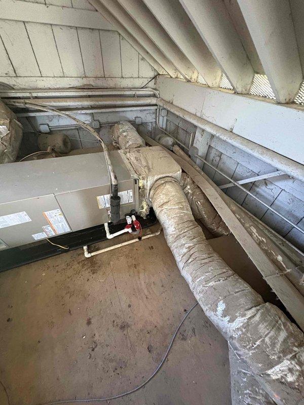 Completed full residential heat pump system installation including Bryant 2-ton outdoor heat pump unit (model GH5SAN52400A), Bryant 2-ton air handler (model FJ5ANXB24L00), and Bryant 10 kW electric heat kit (model TU-EC-10BKB) with digital thermostat. Installed outdoor unit pad with snow legs, electrical whip kit, and disconnect box for code-compliant power supply. Applied refrigerant line insulation and installed refrigerant line filter for system protection. Added foil duct wrap to insulate exposed sections of supply ductwork where deterioration was evident. Configured air handler with condensate trap, SS2 coil drain safety water sensor, and ceiling saver overflow drain pan with secondary water sensor for leak protection. Fabricated transition connections to integrate with existing ductwork system and installed standard-sized air filter rack. Removed and disposed of existing HVAC equipment per regulations. Pulled all applicable permits and completed installation to current code requi