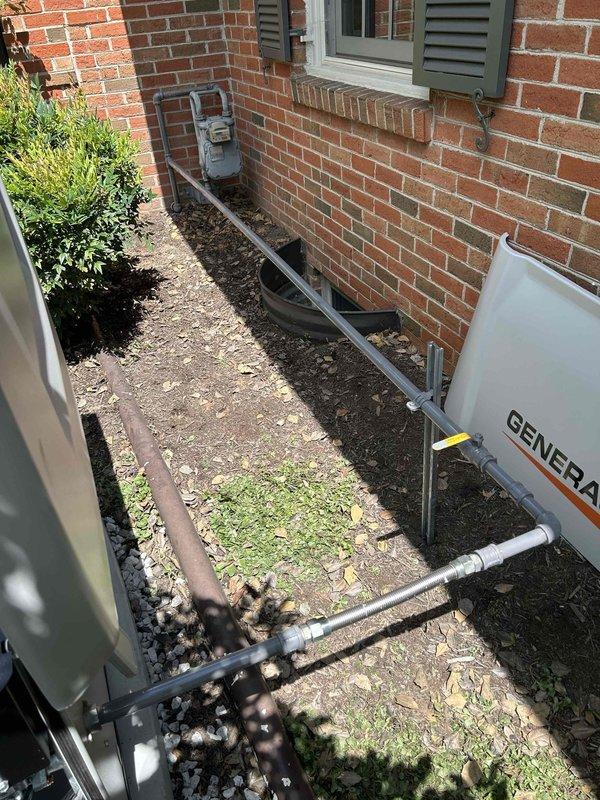 Installed new gas piping system from existing natural gas meter to standby generator unit, including routing gray metal pipe along exterior brick wall with proper mounting and support. Installed dedicated shut-off valve for generator isolation, pressure tested entire gas line assembly for leaks, and verified proper operation of generator upon system activation.