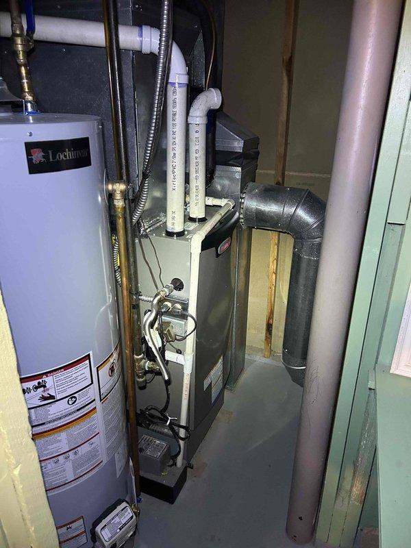 Responded to no cooling complaint with home temperature rising to 80-81°F instead of maintaining 78°F setpoint. Upon arrival, performed comprehensive system evaluation of split air conditioning system with aging outdoor condenser unit and recently replaced furnace. Conducted visual inspection of outdoor equipment positioned on concrete pad, noting weathered condenser unit with dirt accumulation on coil fins and cabinet surfaces. Inspected indoor air handler and furnace installation in mechanical room, verifying proper installation of ductwork and venting systems. Performed diagnostic testing to identify root cause of inadequate cooling capacity and inability to maintain desired temperature setpoint. Documented equipment conditions through photographic records showing outdoor condenser installation with associated plumbing components and indoor HVAC equipment configuration. Evaluated system operation and airflow characteristics to determine performance deficiencies affecting whole-house