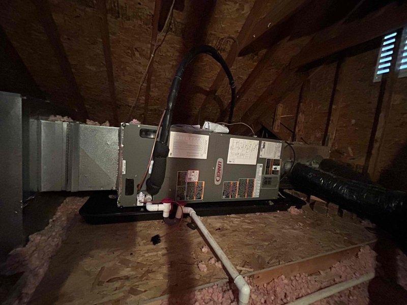Completed full residential HVAC system upgrade, converting existing air handler and air conditioning system to a complete heat pump system. Installed Lennox Merit Series ML14KP1-024-230 2-ton 15.2 SEER2 heat pump outdoor unit, Lennox CBK45UHET-024-71 2-ton air handler in attic space, and Lennox ECB45-10CB-P 10kW heat kit for auxiliary heating. Upgraded thermostat wiring to accommodate heat pump operation and installed new digital thermostat for proper system control.

Installation included outdoor unit placement on concrete pad with gravel surround, snow legs for elevation, electrical disconnect box, and electrical whip kit for proper power supply. Installed insulated refrigerant lines with inline filter connecting outdoor condenser to indoor air handler. Mounted air handler horizontally on attic floor with proper support and clearances, connected to existing ductwork via custom transition fittings.

Installed comprehensive condensate drainage system including primary drain trap, SS2 c