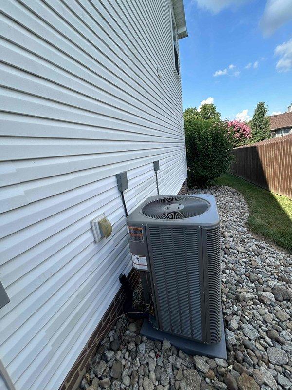 Completed full residential HVAC system upgrade, converting existing air handler and air conditioning system to a complete heat pump system. Installed Lennox Merit Series ML14KP1-024-230 2-ton 15.2 SEER2 heat pump outdoor unit, Lennox CBK45UHET-024-71 2-ton air handler in attic space, and Lennox ECB45-10CB-P 10kW heat kit for auxiliary heating. Upgraded thermostat wiring to accommodate heat pump operation and installed new digital thermostat for proper system control.

Installation included outdoor unit placement on concrete pad with gravel surround, snow legs for elevation, electrical disconnect box, and electrical whip kit for proper power supply. Installed insulated refrigerant lines with inline filter connecting outdoor condenser to indoor air handler. Mounted air handler horizontally on attic floor with proper support and clearances, connected to existing ductwork via custom transition fittings.

Installed comprehensive condensate drainage system including primary drain trap, SS2 c