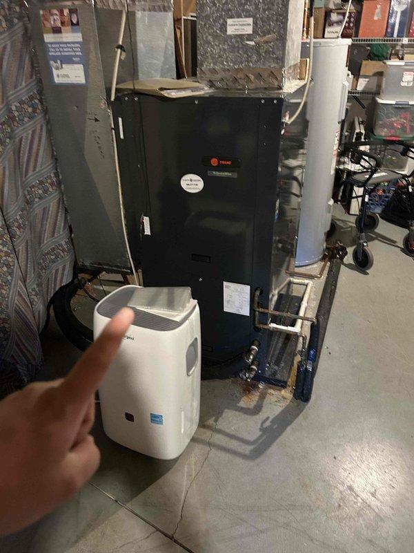 Responded to no cooling call affecting both upstairs and downstairs HVAC systems. Upon inspection, found Trane air handler in basement with multiple system faults indicated on control panel, including drain, pressure, and airflow error codes. Customer utilizing temporary portable air conditioning unit for interim cooling while systems remain non-operational.