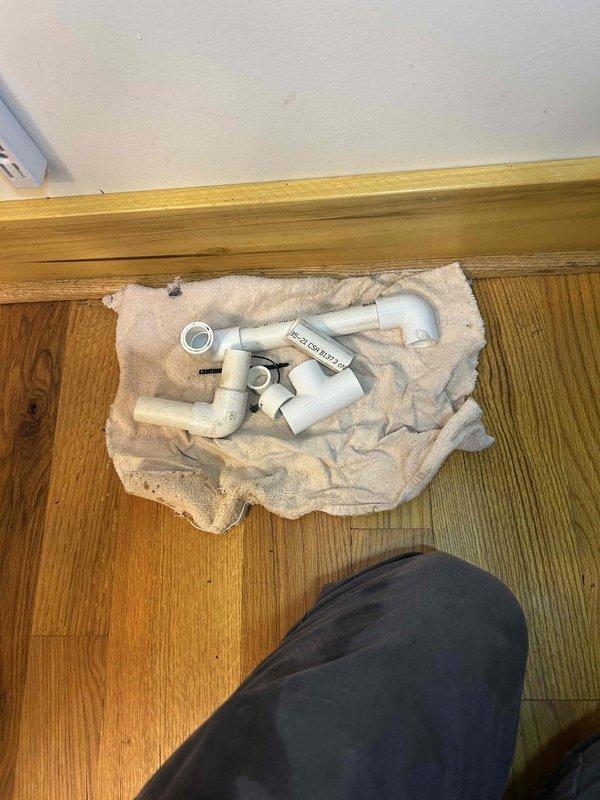 Responded to post-installation callback at guest house to address improperly secured vent cover and remaining installation debris. Properly reinstalled and secured wall-mounted return air vent cover with appropriate fasteners. Collected and removed leftover PVC components and materials from installation site, restoring work area to clean condition.