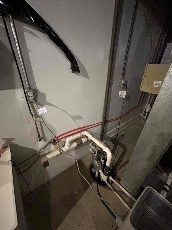Relocated existing sump pump receptacle to a higher elevation on the wall to improve safety and accessibility. Installed a new dedicated 120V 20-amp circuit for the sump pump system, routing the wiring through liquid-tight flexible metallic conduit that runs vertically down the wall for proper protection and code compliance. All electrical connections were secured in approved junction boxes with proper wire management, ensuring the sump pump system operates safely and reliably in the utility space.