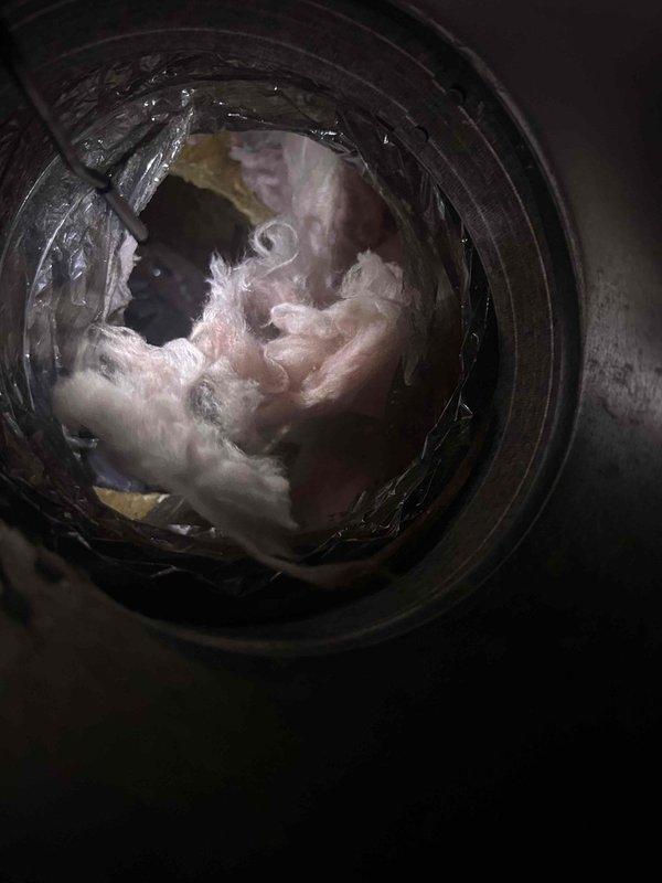 Responded to callback for system not cooling following previous day's TXV and filter drier replacement. Upon inspection, used endoscope camera to investigate ductwork and discovered significant lint and debris accumulation blocking airflow in supply duct. Removed obstruction and restored proper airflow to system, resolving cooling issue.