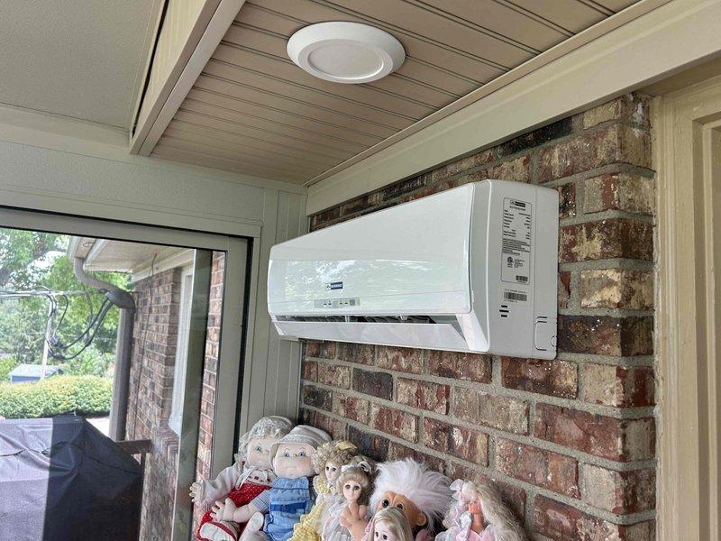 Responded to service call for ductless mini-split system with no cooling or heating capability and unresponsive control interface. Upon arrival, found wall-mounted indoor unit installed in enclosed porch area. Performed diagnostic evaluation of system, including temperature measurements at discharge vents which registered 65.8°F. Inspected control panel functionality and verified power supply to unit. Documented equipment condition and current operational status with photographic evidence for service records.