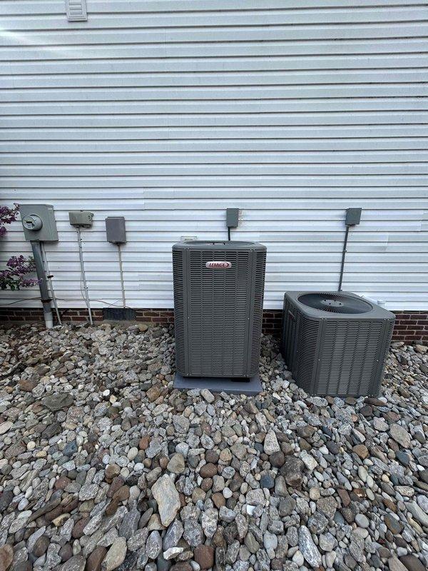 Completed full HVAC system replacement including installation of Carrier 4-ton 16 SEER2 heat pump (model GH5SAN54801A), Carrier 4-ton air handler (model FJ5ANXC48L00) in attic space, and Carrier 20kW heat kit (model TU-EC-20BKB) with digital thermostat. Removed and properly disposed of existing equipment, installed outdoor unit on gravel pad with snow legs, electrical disconnect box, electrical whip kit, insulated refrigerant lines, and refrigerant line filter. Completed all electrical connections via conduit to exterior wall-mounted components, pulled applicable permits, and verified system operation and code compliance.