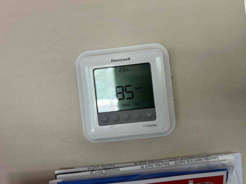 Responded to no cooling complaint on Goodman AC system installed in 2020. Upon arrival, thermostat displayed 95°F indoor temperature with unit running but delivering room temperature air through supply registers. Inspected outdoor condensing unit model PSSC0186H1GB and found system operational but not producing cooling. Diagnosed refrigerant circuit issue preventing proper heat transfer. System requires refrigerant charge verification and potential leak detection to restore cooling capacity.