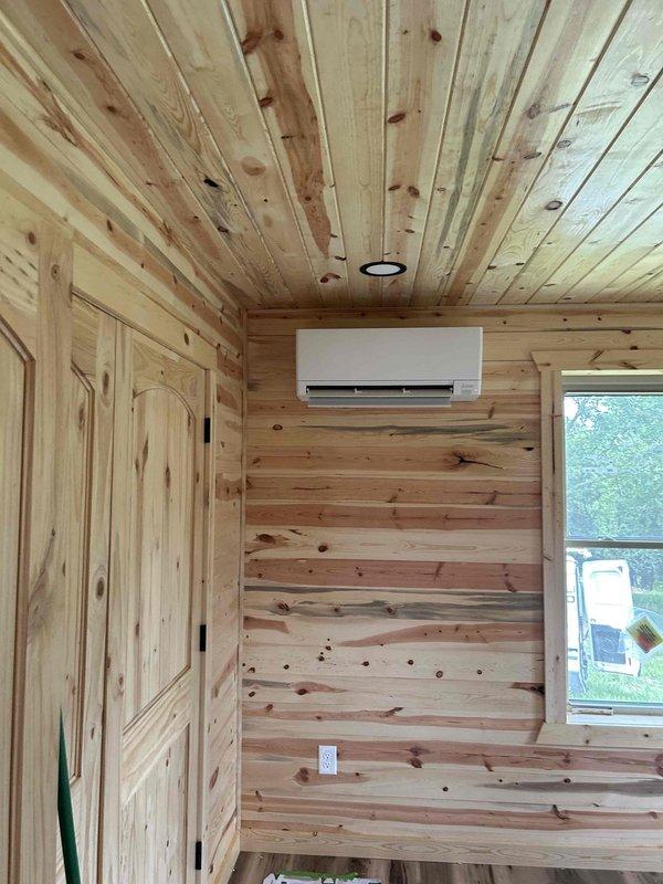 Completed residential installation of a three-zone Mitsubishi hyper heat ductless mini-split system consisting of one MXZ-3D30NLHZ 30,000 BTU outdoor heat pump unit and three indoor wall-mounted blower sections: one MSZ-GX18 18,000 BTU unit and two MSZ-GX06 6,000 BTU units installed in bedrooms. All lineset piping and low-voltage communicating wiring between indoor and outdoor units were concealed within walls for a clean installation. Condensate drain lines were routed to exterior downspouts and crawlspace drain locations. The outdoor unit was mounted on a customer-supplied stand with equipment pad and rubber isolation pads. Installation included ductwork for bathroom exhaust and dryer exhaust terminations with brown-colored exterior vent covers per specification. System was evacuated, pressure tested, and charged with R-410A refrigerant to manufacturer specifications, with final micron gauge readings confirming proper vacuum levels. All required permits obtained and inspections compl