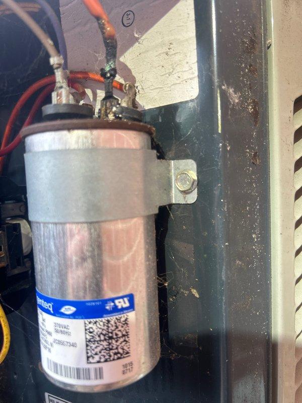 Responded to no cooling complaint on 5-7 year old electric air conditioning system with downstairs unit blowing warm air. Upon inspection, diagnosed failed capacitor preventing compressor operation. Replaced defective capacitor with new unit, restored proper electrical connections, and verified system operation with compressor running and cold air delivery restored to normal parameters.