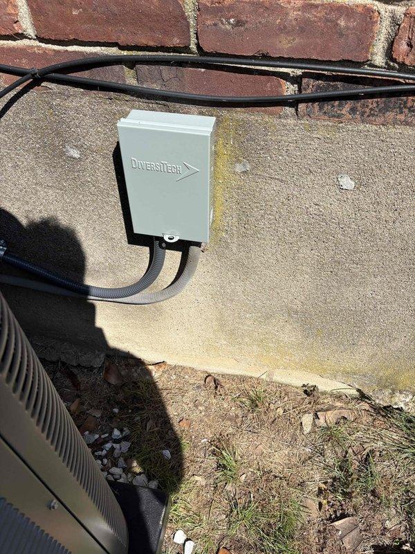 Completed full HVAC system installation including a Lennox ML14KC1-024-230 2-ton 15 SEER2 air conditioning condenser unit and Lennox CK40CT-18/24B-71 evaporator coil. Removed and properly disposed of existing equipment, then installed new outdoor condenser unit on concrete pad with gravel base alongside brick exterior wall. Mounted electrical disconnect box on wall with conduit run and installed electrical whip kit for power connection. Installed evaporator coil in air handler with transition to existing ductwork, including refrigerant line insulation and filter drier. Ran and insulated refrigerant lines between outdoor and indoor units, then evacuated system and charged to manufacturer specifications. Installed SS2 coil drain safety water sensor for secondary drain pan protection. Integrated system with existing thermostat, verified all electrical connections, and performed complete operational testing of cooling cycle. All work completed per code requirements with applicable permits 