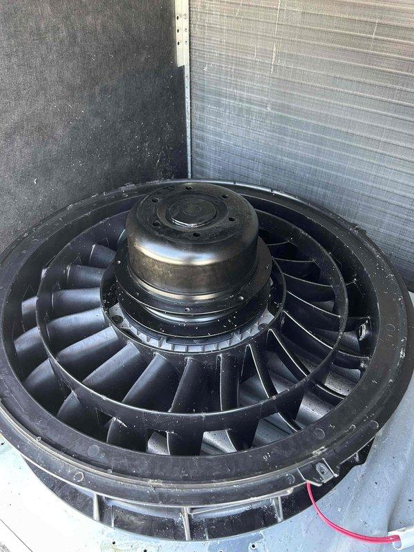 Performed commercial HVAC maintenance on blower assembly and make-up air system. Cleaned blower wheel to remove accumulated dust and debris, and replaced make-up air filter. Unit showed evidence of frost accumulation on fan housing and components, indicating proper operation under cold conditions.