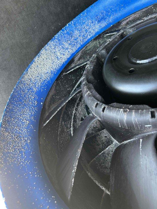 Performed commercial HVAC maintenance on blower assembly and make-up air system. Cleaned blower wheel to remove accumulated dust and debris, and replaced make-up air filter. Unit showed evidence of frost accumulation on fan housing and components, indicating proper operation under cold conditions.
