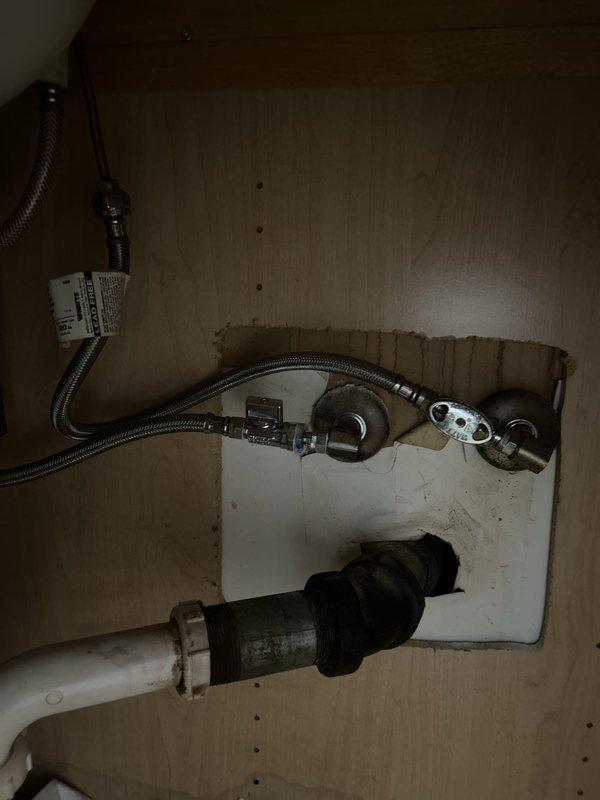 Replaced a leaking shut-off valve for the bathroom sink with a new angle stop assembly. The original valve was failing and causing water seepage in the vanity cabinet, which was successfully resolved with the installation of the new fixture and braided supply line connection.