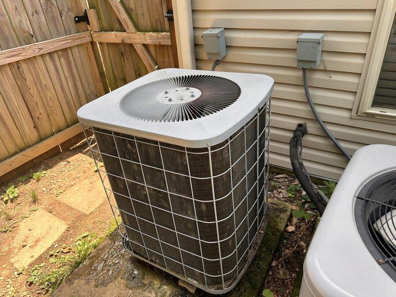 Responded to service call for R22 system experiencing frozen evaporator coil with heat pump and air handler located in attic requiring ladder access. Performed comprehensive evaluation of dual HVAC system configuration, including approximately 20-year-old primary unit and secondary system of undetermined age. Assessed both systems' current heating and cooling functionality, documented attic installation with limited clearance conditions, and inspected outdoor condenser units positioned on concrete pads against exterior wall. Provided replacement estimate for aging equipment and discussed Google Nest thermostat installation options with property owner.