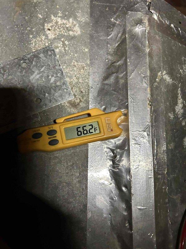 Responded to no cooling call on 4-year-old electric heat pump system with indoor unit located in garage. Performed diagnostic assessment of reported refrigerant leak and evaporator coil issue. Evaluated airflow concerns at multiple supply vents and investigated condensation problem at return air intake. Measured supply air temperature at 55.5°F and return air temperature at 66.2°F, confirming reduced cooling capacity and inadequate temperature split. Inspection revealed compromised airflow delivery through ductwork system, likely contributing to condensation issues and weak air distribution throughout living space. Documented current system conditions with thermal measurements at supply and return ducts in attic space.