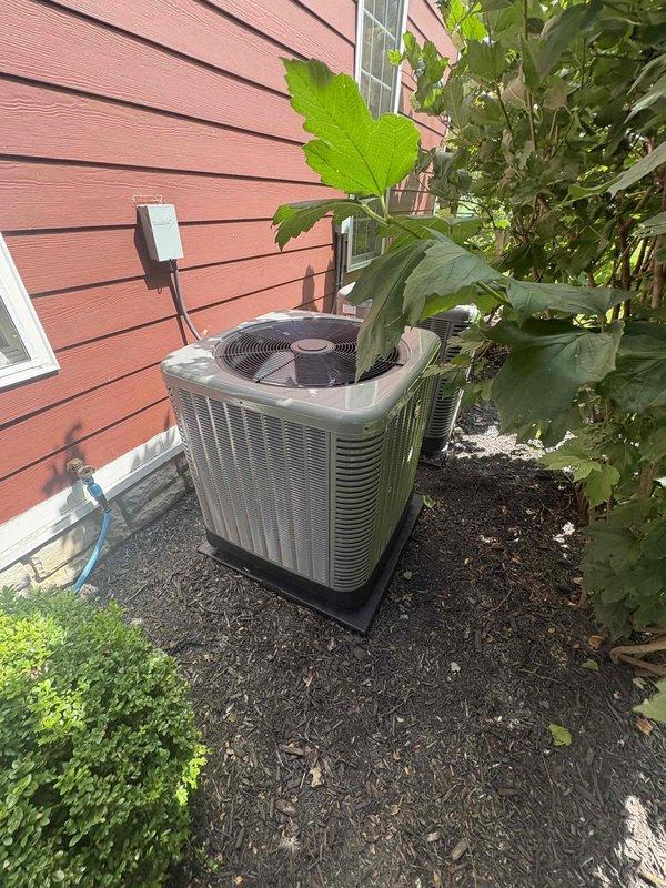 Completed full HVAC system replacement installing a RUUD 14.3 SEER2 two-stage 3-ton heat pump system consisting of RP14AY36 outdoor heat pump unit, RH2TY36 air handler with 15KW auxiliary heat kit, and digital thermostat. Removed and properly disposed of existing equipment per code requirements. Installed outdoor condenser on new pad with snow legs, mounted electrical disconnect box with whip kit connection, and ran insulated refrigerant lines with inline filter. Configured indoor air handler with coil drain trap, SS2 drain safety water sensor, ceiling saver overflow drain pan with secondary water sensor, transition to existing ductwork, and standard air filter rack. Pulled all applicable permits, verified electrical connections meet code compliance, pressure tested refrigerant system, evacuated lines, charged system to manufacturer specifications, and performed full operational testing of heating and cooling modes across both stages. System commissioned successfully with proper airflo