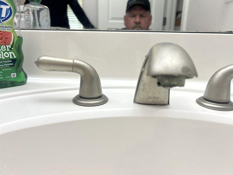 Completed comprehensive 65-point whole home plumbing inspection examining all fixtures, supply lines, drain systems, and water pressure throughout the property. Inspected and addressed multiple dripping faucets, including a Delta three-piece bathroom sink faucet set and a chrome shower/tub control valve, checking for worn washers, cartridge issues, and proper operation. Documented conditions with photographs and provided assessment of plumbing system functionality and recommendations for any necessary repairs.