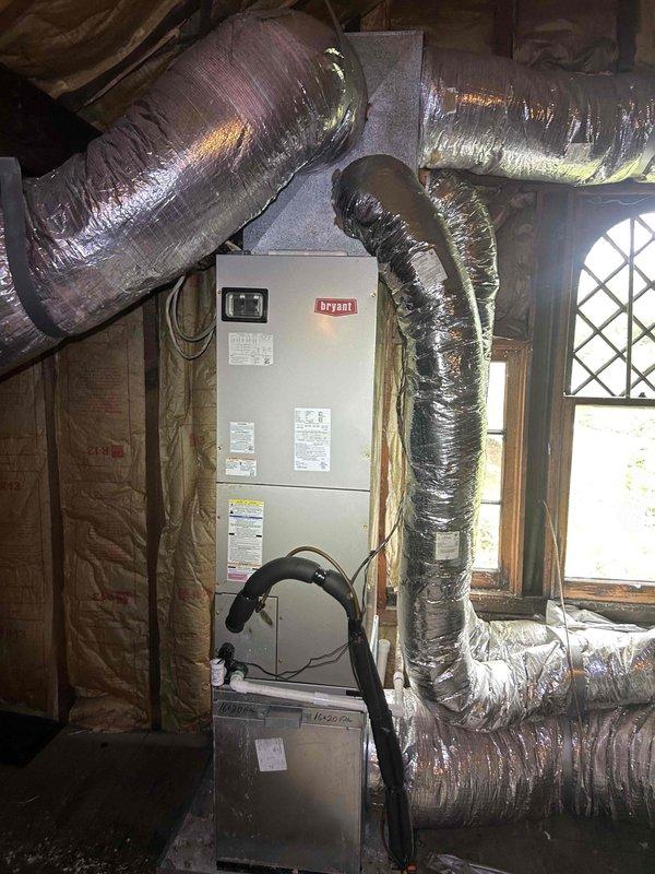 Responded to no-cool call on 3-year-old Bryant electric AC system serving upstairs zone. Upon arrival, found thermostat blank with no power. Diagnosed loss of power to air handler located in attic space. Inspected evaporator coil assembly and confirmed unit had accumulated dust and debris between fins. Restored power to system, verified proper operation of air handler and condensate drain pan. System returned to normal cooling operation with thermostat functioning properly.