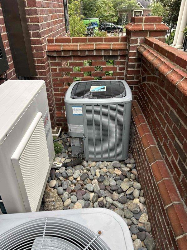 Responded to callback for system that would not operate following previous thermostat scheduling service. Upon arrival, thermostat displayed "cooling on" but outdoor unit showed no signs of operation. Inspected Trane condenser unit located in brick-enclosed courtyard area with multiple HVAC systems. Found significant accumulation of dirt, debris, and biological growth in lower equipment compartment that had developed since previous visit. Cleaned contaminated areas, verified electrical connections at component level, and restored system to normal operation. Unit tested successfully with proper cooling cycle engagement and thermostat communication confirmed.