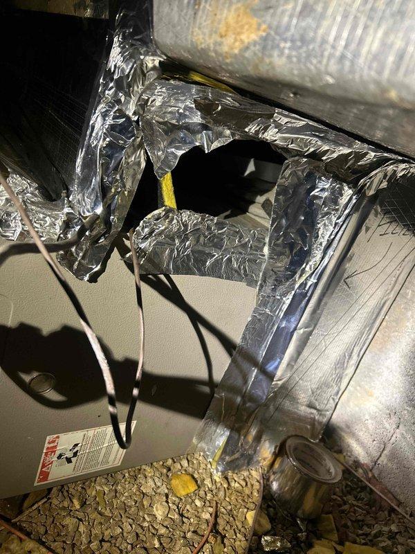 Completed full MTU inspection of two HVAC systems for residential property under contract. One system located in garage-accessible mechanical room, second system in crawl space accessed beneath rear deck. Inspection revealed multiple deficiencies requiring attention: master bedroom unit's furnace vent pipe improperly attached and disconnected from air handler, copper refrigerant line lacking proper insulation, and significant damage to flexible ductwork insulation with torn sections compromising system efficiency. Documented all findings with photographic evidence showing loose-fill insulation conditions, HVAC equipment placement, and specific deficiency locations. Both outdoor condensing units inspected on hillside installation adjacent to garage. Provided comprehensive assessment of both aging systems for pre-purchase evaluation purposes.