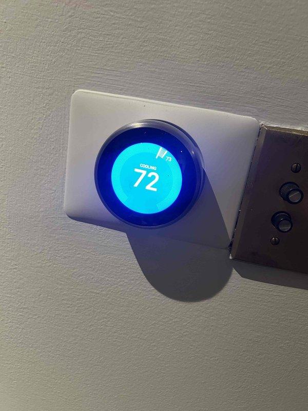 Provided estimate for replacement of three existing thermostats located in attic, bedroom, and downstairs living area. Customer expressed concerns regarding current Nest thermostat's auto-adjustment functionality not operating as desired. Documented existing equipment including smart thermostat models currently installed and discussed upgrade options to address performance issues.