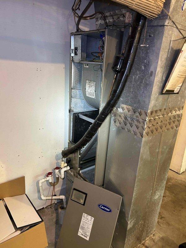 Responded to no cooling or airflow complaint on 11-year-old Carrier heat pump system with air handler located in garage. Upon arrival, performed comprehensive diagnostic evaluation of both indoor air handler unit and outdoor condensing unit. Inspected thermostat operation and verified proper power supply to system components. Examined air handler cabinet, blower motor assembly, and ductwork connections for obstructions or mechanical failures. Checked electrical connections, capacitors, and control board functionality. Assessed refrigerant lines, condensate drain system, and all safety switches. Identified root cause of system failure and provided customer with repair options and recommendations for restoring cooling operation and airflow to the residence.