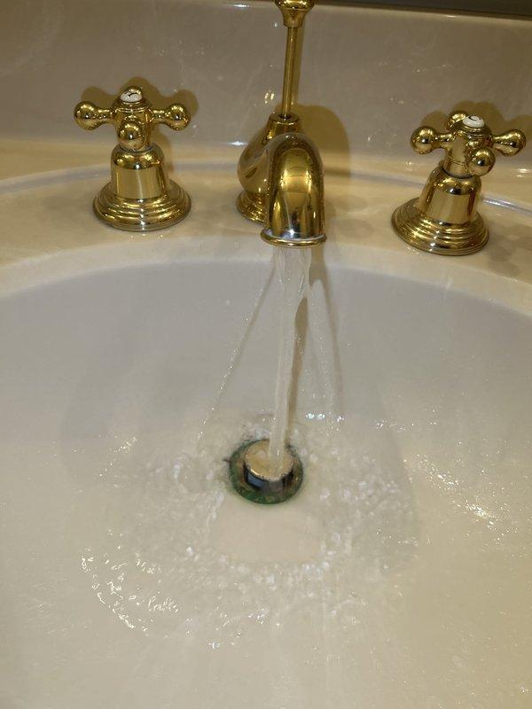 Completed routine plumbing inspection addressing reported loose fixtures. Inspected and tightened loose bathroom faucet assembly and secured two loose components in shower area. Verified proper operation of three-handle brass faucet set, confirmed water flow and drainage functioning correctly, and ensured all fixtures were properly secured to prevent future issues.