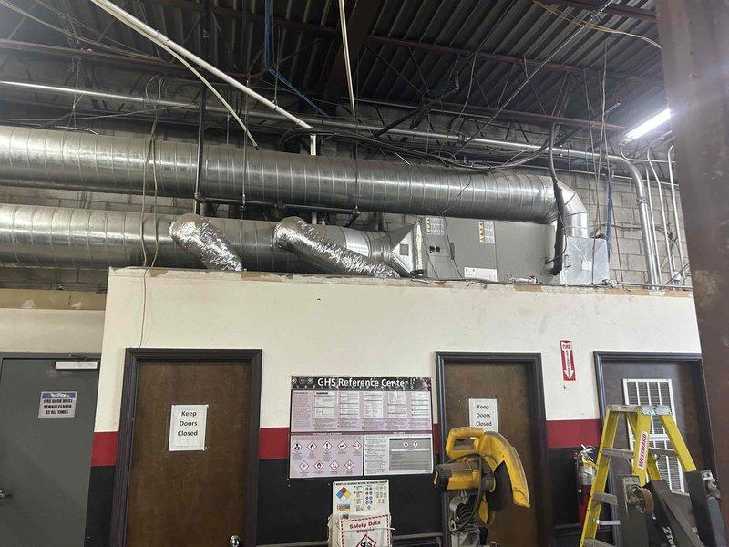 Responded to service call for HVAC system producing abnormal noise at commercial facility. Upon arrival, located affected unit mounted above interior wall with connected spiral ductwork. Performed diagnostic testing using digital multimeter, measuring capacitor at 70 microfarads to verify compressor and fan motor electrical components. Inspected rooftop outdoor condensing units and attic-mounted equipment as part of system assessment. Captured documentation of testing procedures and equipment location for service records.