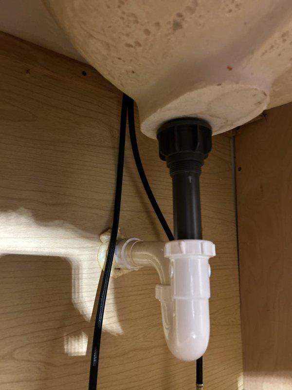 Responded to service call to reconnect kitchen plumbing fixtures including garbage disposal, sink drain assembly, and dishwasher. Successfully reinstalled and secured all plumbing connections under sink, ensuring proper P-trap installation and verifying all drain lines were leak-free and functioning correctly.