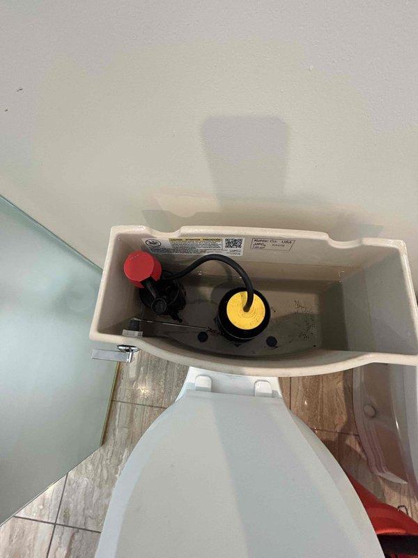 Responded to service call for toilet stoppage issue. Upon arrival, assessed the toilet and determined a clog was present in the drain line. Utilized manual drain auger to clear the obstruction from the toilet trap and drain system. Successfully removed blockage and restored proper drainage function. Inspected toilet tank components including flush valve assembly, fill valve, and flapper mechanism to ensure all internal parts were operating correctly. Verified water level and flush operation were within normal parameters. Tested toilet multiple times to confirm complete clearance of stoppage and proper waste evacuation. Left fixture in full working order with no further issues detected.