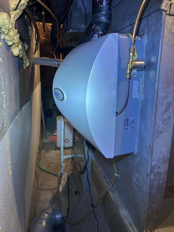 Completed preventive maintenance tune-up on Ingersoll Rand air conditioning unit and humidifier system located in basement. Performed comprehensive inspection of equipment, changed air filters, replaced humidifier pad #210, and documented equipment model and serial numbers with photographs. All systems operating within normal parameters upon completion of maintenance service.