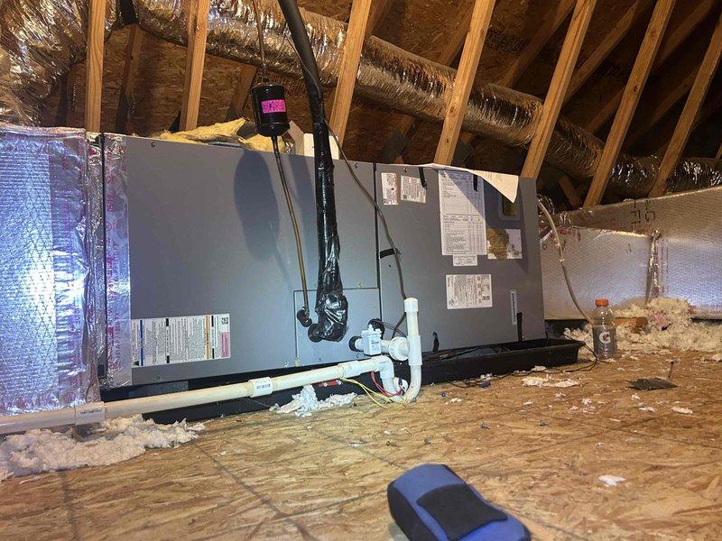 Responded to no cooling complaint on 5-year-old upstairs heat pump system with blank ION thermostat. Upon inspection, discovered control board in air handler had complete power failure. Found biological growth (mold/algae) on control board surfaces, insulation, and condensate components, indicating prolonged moisture intrusion. Traced issue to clogged condensate drain system causing water backup onto circuit board and electrical connections. Cleaned affected areas, cleared condensate line blockage, and replaced damaged control board and corroded wiring connections. Verified proper drainage, tested all electrical connections at terminal blocks, and confirmed system operation with thermostat responding correctly and unit cooling properly.