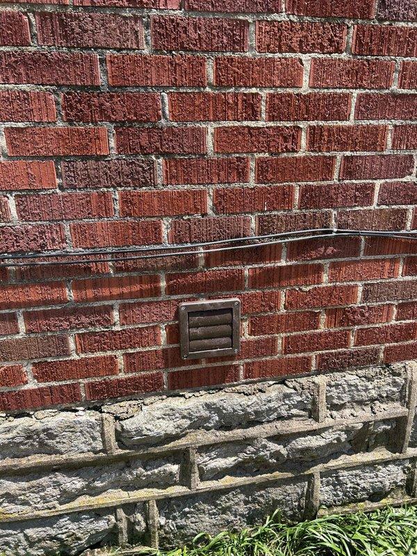 Relocated dryer vent from window opening to exterior wall ban board. Installed new venting system using 4-inch metal pipe, four 26-gauge 90-degree elbows, one 4x4x4 tee fitting, and terminated with white dryer vent cap on brick exterior. Secured all ductwork connections and capped previous opening to ensure proper airflow and code-compliant installation.