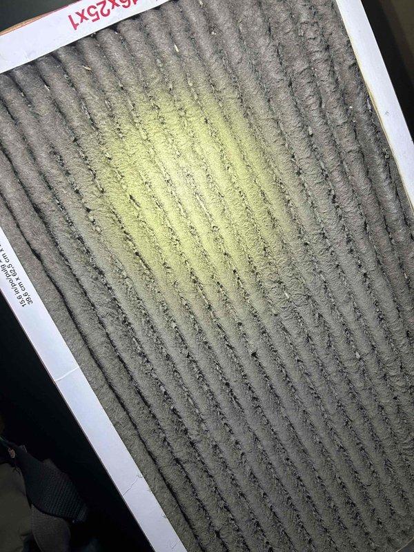 Responded to no cooling call on 10-year-old electric HVAC system with no thermostat display. Upon arrival, located indoor unit in basement and performed diagnostic evaluation. Found severely clogged air filter with significant debris accumulation causing restricted airflow. Discovered extensive condensation on interior cabinet surfaces indicating possible drain line issues or inadequate airflow. Removed and replaced dirty air filter to restore proper system airflow. Cleared condensate drain line and verified proper drainage. Tested system operation and confirmed thermostat display restored and unit cycling properly. Air conditioning system returned to normal cooling operation with adequate airflow at registers.