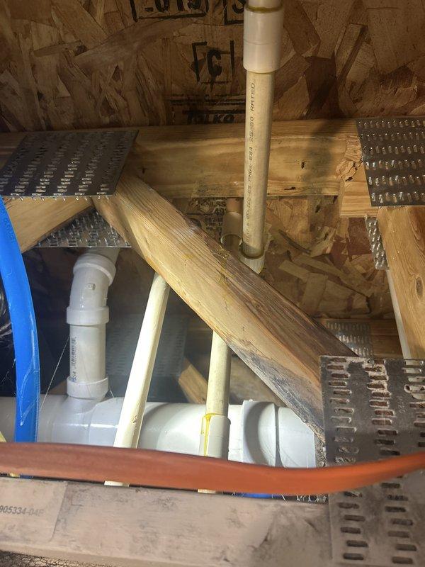 Responded to steady water leak reported in utility closet ceiling between units 218 and 219. Upon arrival, accessed attic crawl space and inspected exposed plumbing system, including PVC drain and vent lines running through ceiling joists. Documented conditions with photographs showing pipe routing, support strapping, and surrounding structural elements. Identified active dripping and traced source through visual inspection of pipe connections and joints in the affected area. Assessed installation of plumbing lines relative to insulation and radiant barrier materials to determine leak origin point.