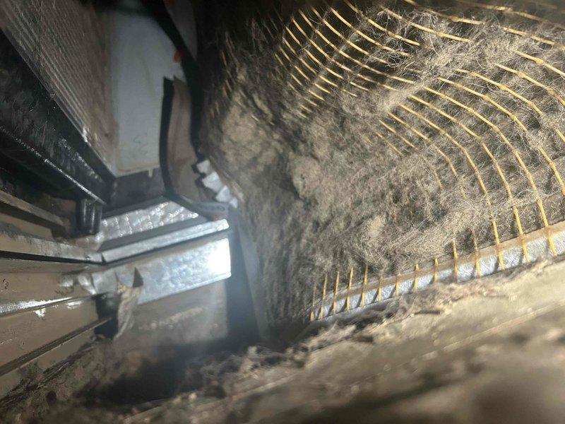 Responded to no cooling call on three-month-old system with indoor temperature at 82°F and outdoor unit failing to operate. Upon inspection, discovered evaporator coil completely blocked with excessive dust and debris accumulation, restricting airflow and causing severe icing on refrigerant lines. Filter was saturated with condensation due to restricted airflow and temperature differential across the coil. Cleaned evaporator coil, removed ice buildup from refrigerant lines, replaced saturated filter, and restored proper system operation. Verified outdoor unit engagement and proper cooling cycle restoration before departure.