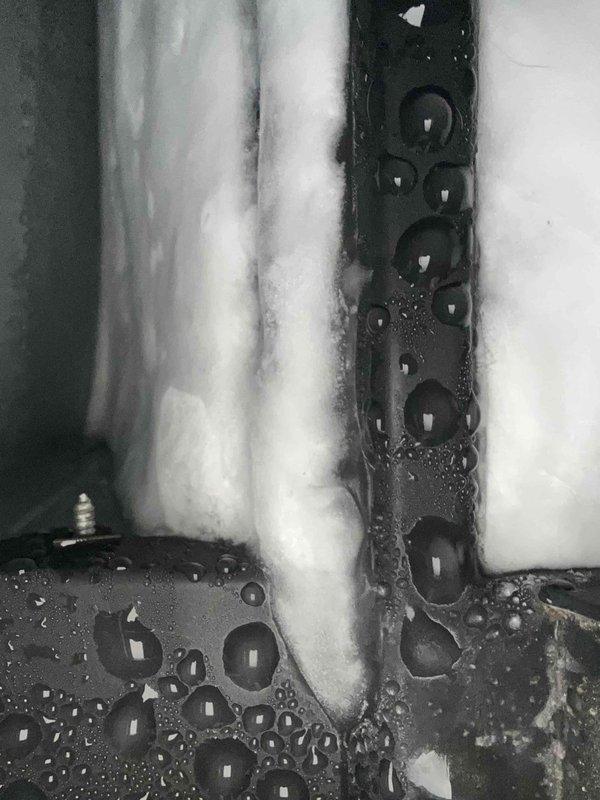 Responded to no cooling call on three-month-old system with indoor temperature at 82°F and outdoor unit failing to operate. Upon inspection, discovered evaporator coil completely blocked with excessive dust and debris accumulation, restricting airflow and causing severe icing on refrigerant lines. Filter was saturated with condensation due to restricted airflow and temperature differential across the coil. Cleaned evaporator coil, removed ice buildup from refrigerant lines, replaced saturated filter, and restored proper system operation. Verified outdoor unit engagement and proper cooling cycle restoration before departure.