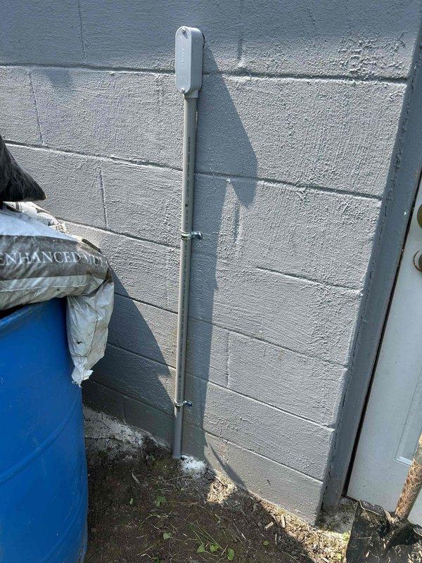 Installed electrical service to detached garage by running new circuit from main panel through exterior-mounted PVC conduit along cinder block wall. Added three new circuit breakers to existing panel and installed GFCI receptacle on interior porch wall to provide safe, code-compliant power access.