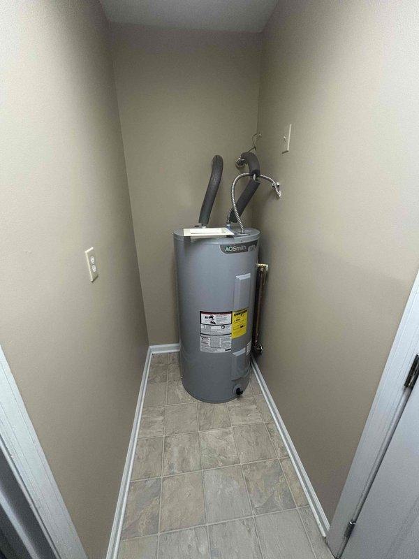 Conducted site assessment for water heater relocation in residential utility space. Current A.O. Smith water heater is positioned in alcove blocking access to washer and dryer hookups. Evaluated existing installation including gas connections, water supply lines, venting system, and electrical requirements. Documented current placement with measurements and photographic evidence. Prepared estimate for relocating unit to alternative position that will provide unobstructed access to laundry connections while maintaining code compliance for clearances, venting, and utility connections.