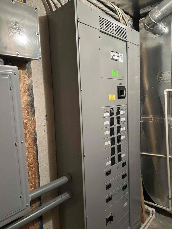 Responded to service call for 10-year-old Generac generator that failed to activate during recent power outage. Performed diagnostic inspection of generator system, transfer switch, and associated electrical panels in basement utility room. Documented existing electrical infrastructure including Generac automatic transfer switch, multiple breaker panels, and wiring configurations for service records.