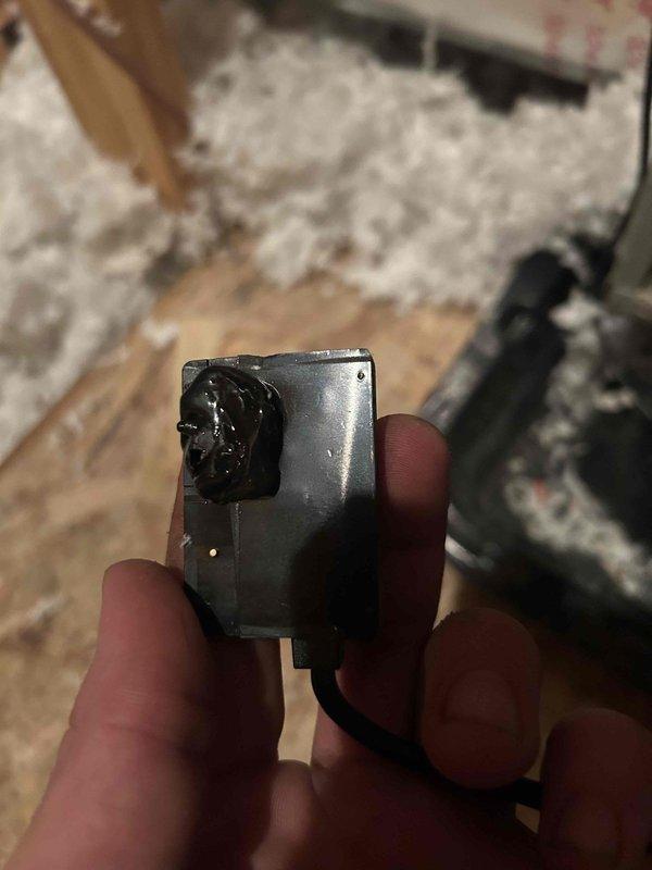 Responded to no cooling call on downstairs heat pump system. Upon inspection of the air handler unit located in attic space, discovered failed transformer with visible burn damage and melted housing. Transformer showed clear signs of thermal failure and was preventing the indoor unit from receiving power. Removed damaged transformer and replaced with new unit, reconnected all control wiring per manufacturer specifications, and restored power to system. Verified proper operation of air handler blower motor and confirmed unit now responds to thermostat calls. System operational at time of departure.