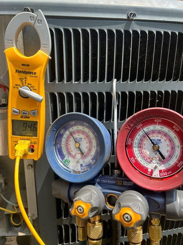 Responded to no cooling complaint on 20-year-old gas system with indoor unit located in crawlspace. Upon arrival, thermostat set to 70°F with indoor temperature reading 80°F. Performed complete system diagnostics using manifold gauge set and clamp meter to assess compressor amperage and refrigerant pressures at outdoor condenser unit. Testing revealed system operational parameters and identified cause of cooling failure. Documented findings with diagnostic equipment readings showing compressor draw at 9.46 amps and refrigerant pressure levels on both high and low side circuits.