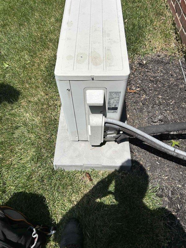 Responded to no cooling complaint on 7-year-old mini split system blowing warm air. Performed diagnostic evaluation of both indoor wall-mounted evaporator unit and outdoor condenser unit. Inspected refrigerant line connections, electrical components, and overall system operation. Documented equipment condition with outdoor unit showing normal wear and indoor unit properly mounted in stairwell area. Completed troubleshooting procedures to identify root cause of warm air discharge issue.