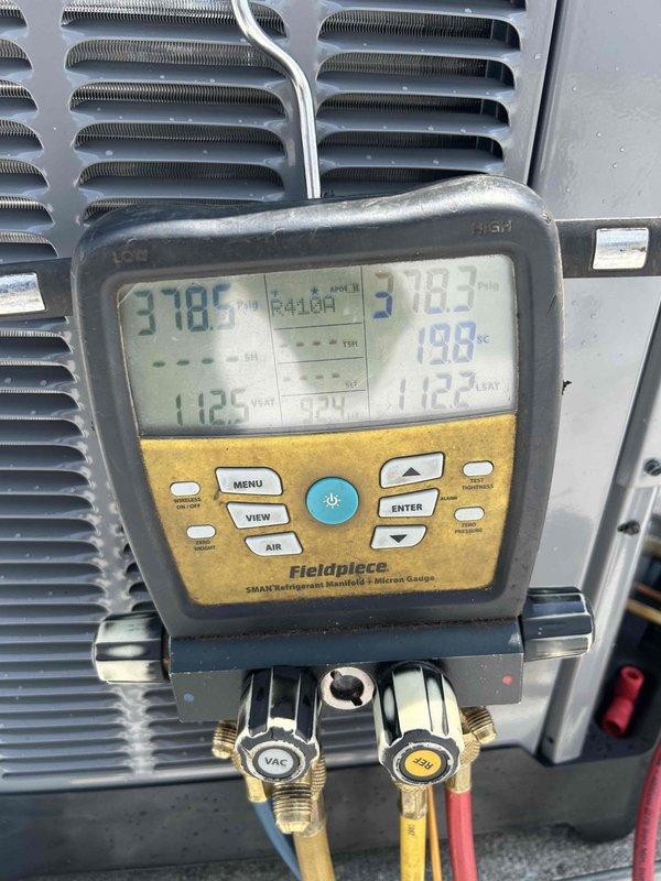 Responded to service call for newly installed HVAC system not cooling adequately, with indoor temperature reading 79°F. Upon arrival, connected refrigerant manifold gauges and verified system pressures and temperatures, which indicated low refrigerant charge. Added 5.00 lbs of refrigerant to system per manufacturer specifications using calibrated digital scale. System now operating within normal parameters and cooling properly.