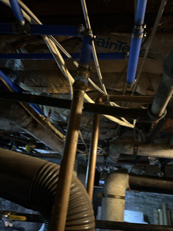 Conducted a comprehensive plumbing estimate for replacement of an existing 40-gallon gas-fired tank water heater located in the basement. Assessed the current installation, including gas supply lines, venting system, pressure relief valve piping, and water supply connections. Documented existing blue PVC condensate drainage system with brass pressure regulator and electronic control components, as well as overhead copper piping infrastructure and mechanical support framework. Evaluated accessibility, clearances, and code compliance requirements for new water heater installation.