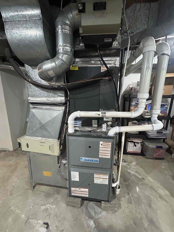 Completed scheduled AC tune-up on a four-year-old Daikin cooling system with no reported issues or symptoms. Performed comprehensive preventive maintenance inspection, verified system operation, and supplied a 20x25x4 filter per customer request. Documented system condition with photos showing proper installation of furnace unit, ductwork, PVC condensate piping, and conducted diagnostic measurements to ensure optimal performance.